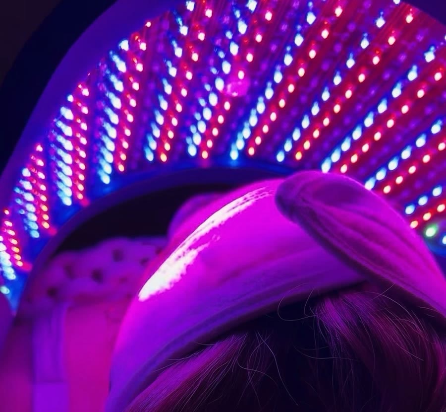 A client resting under the studio's LED light dome
